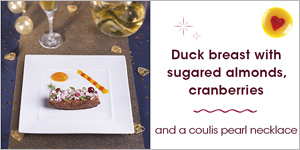 Duck breast with sugared almonds, cranberries, and a coulis pearl necklace